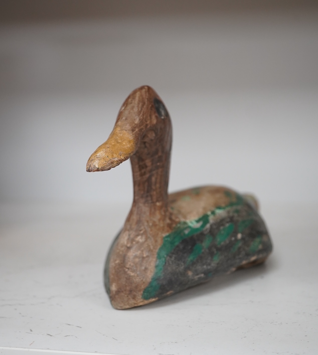 A 19th century painted decoy duck, 31cm long. Condition - worn